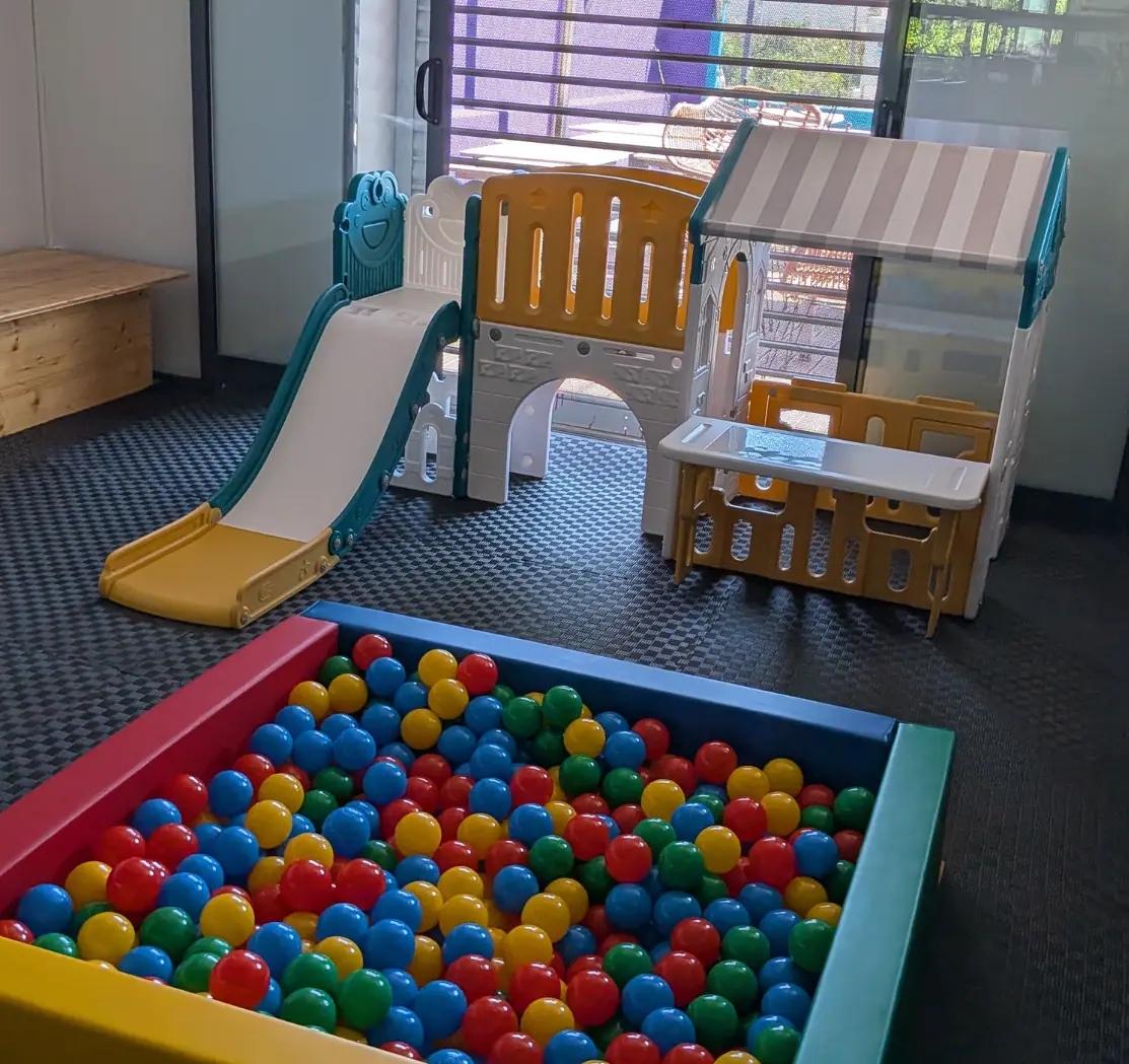 Zazoo's indoor play corner with a toddler slide, playhouse and colourful ball pit