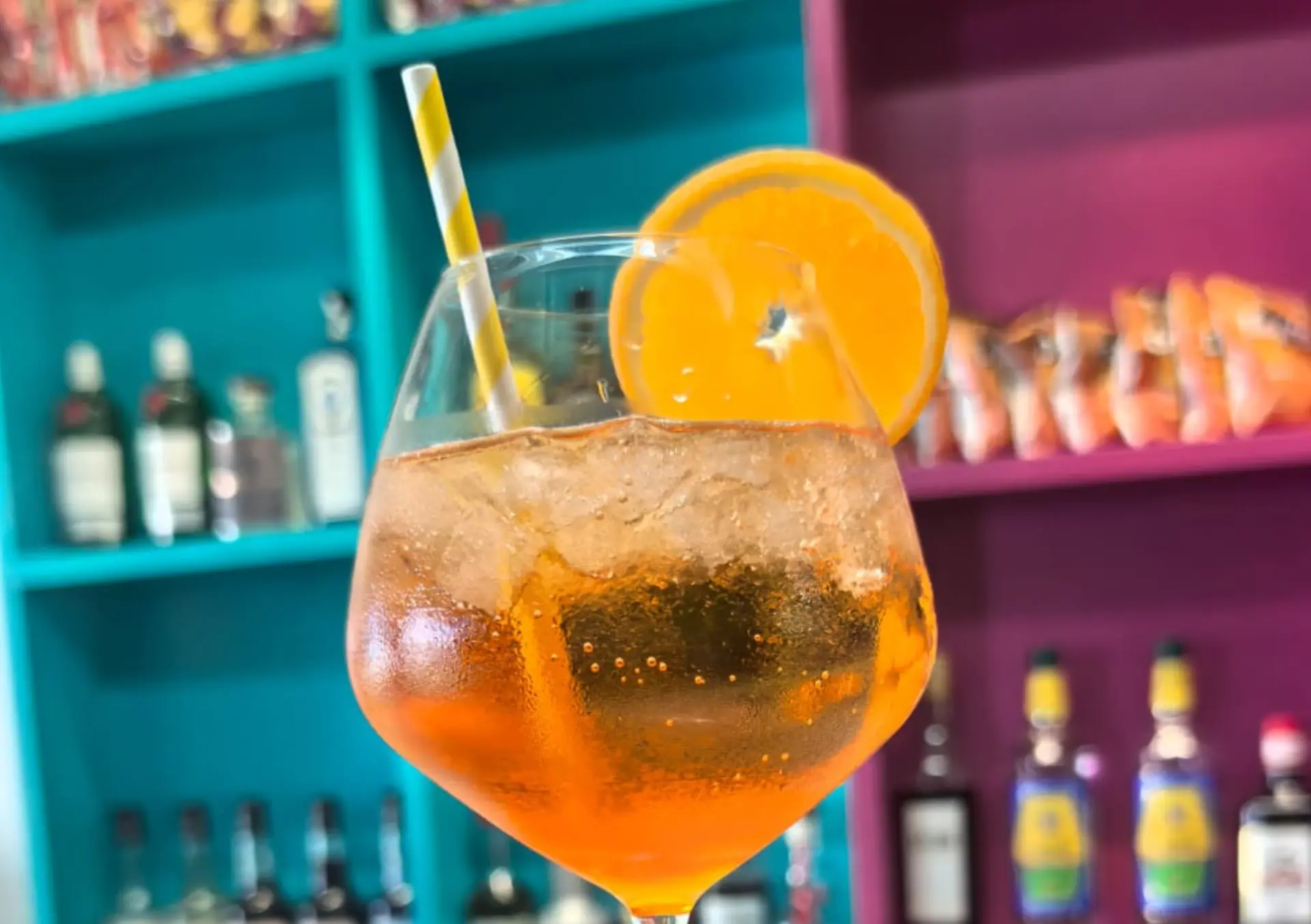 An Aperol spritz with an orange slice at Zazoo's colourful bar