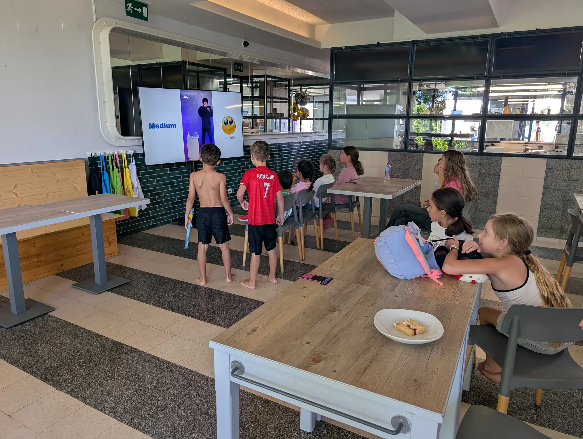 Kids playing an interactive quiz on the screen in Zazoo's indoor play area