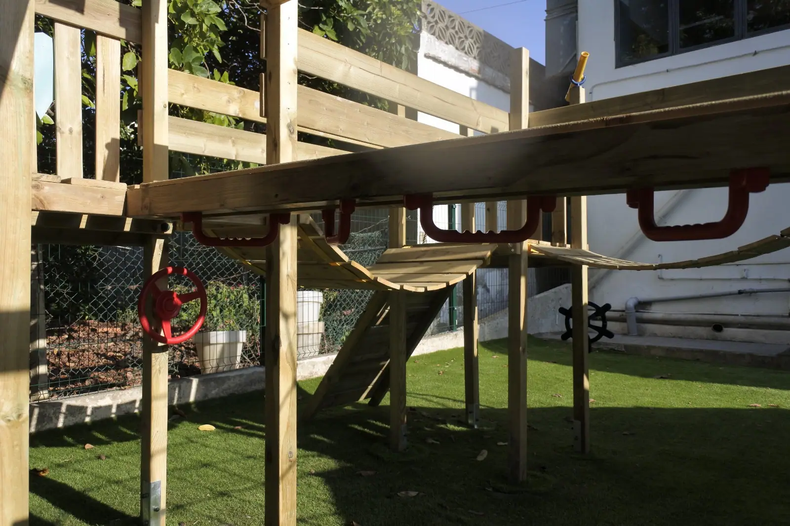 Under Zazoo's wooden play frame, with rope walkways and steering wheels to play with